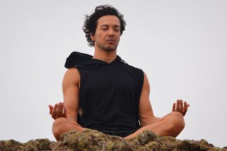 Man meditating peacefully, symbolizing inner calm and spiritual insight beyond religious differences.
